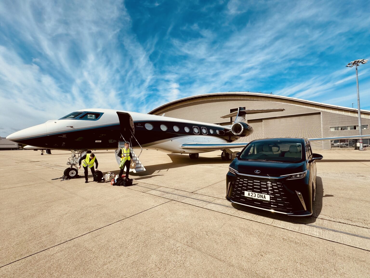 DNA Chauffeur Lexus LM beside a private jet