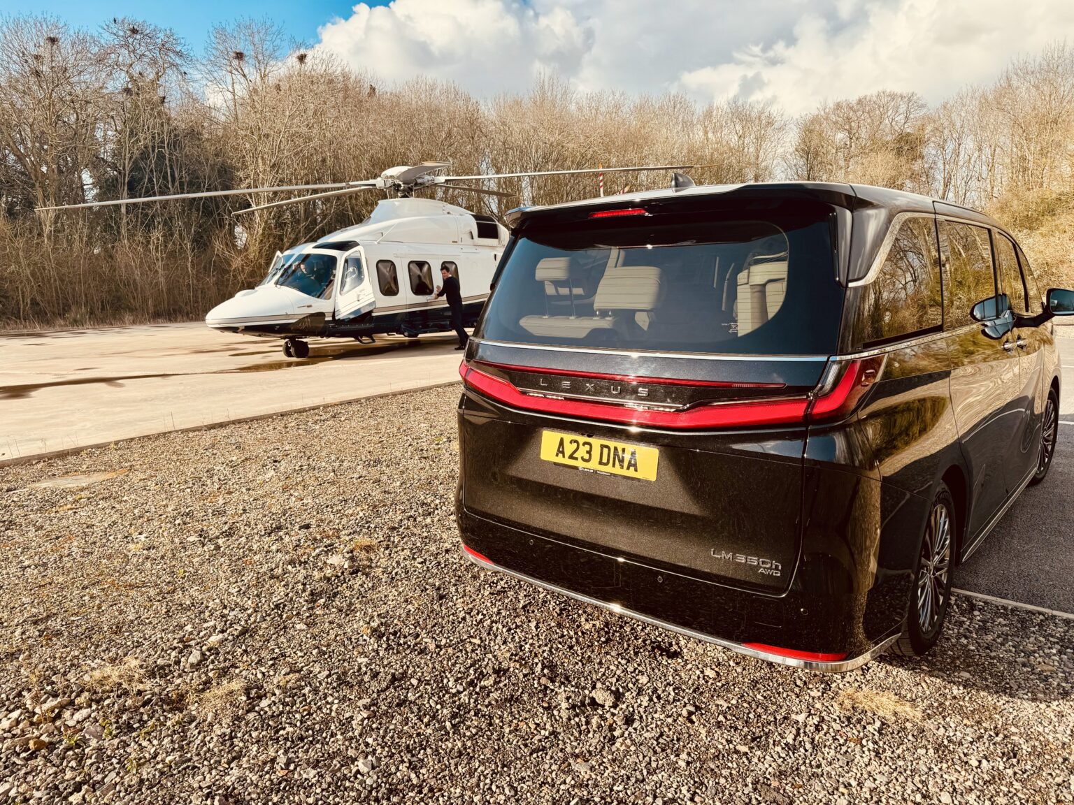Helicopter landing with a DNA Lexus LM waiting
